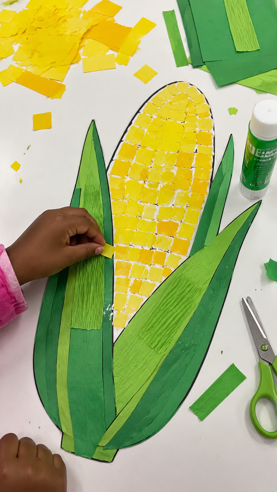 Child-Creating-a-Colorful-Corn-Collage